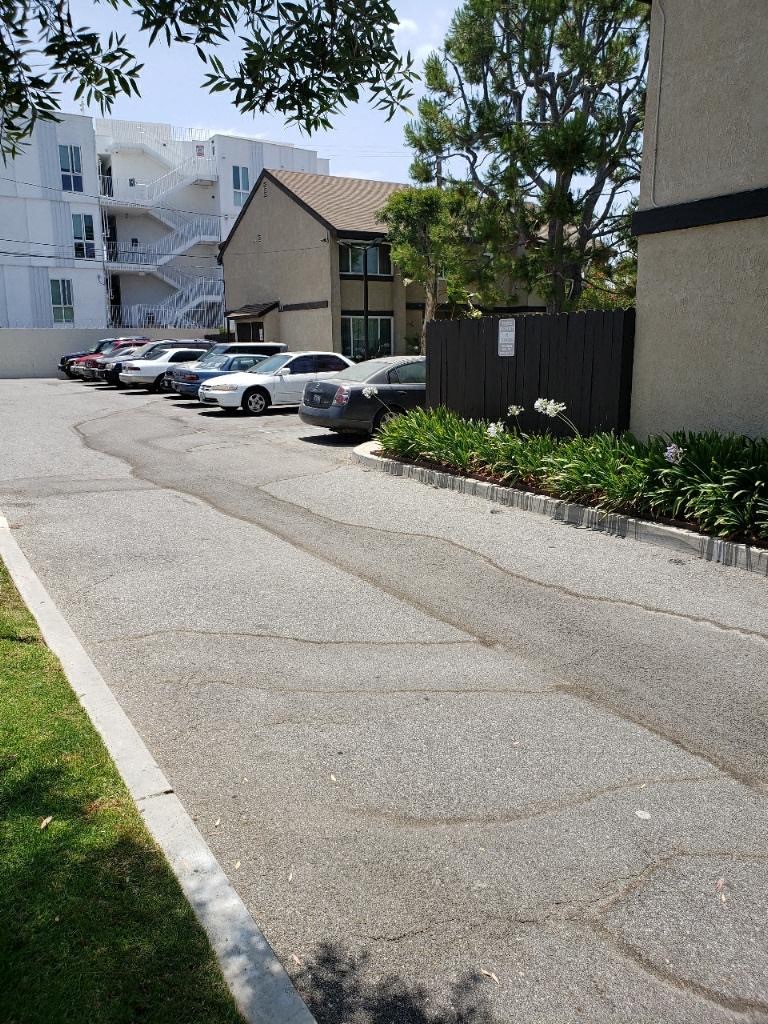 a row of cars parked on the side of a street